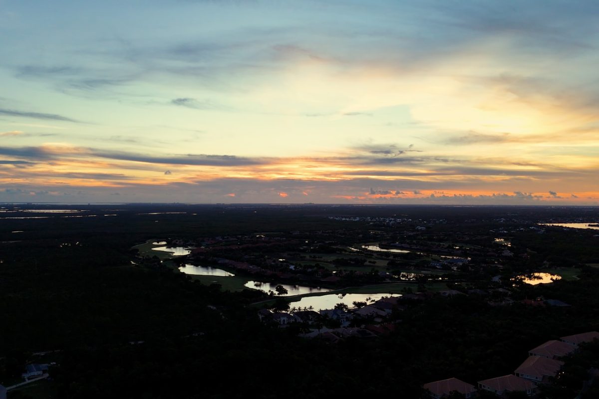 Aerial sunset view of golf course communities in the Naples and Estero area of Southwest Florida